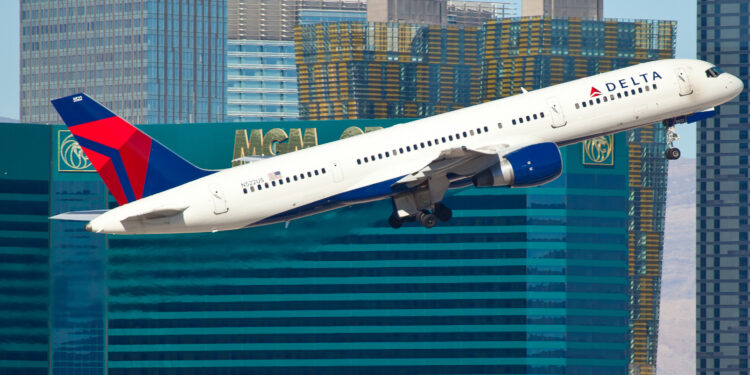 "LAS VEGAS, USA - November 15, 2010: Boeing 757-200 Delta Air Lines climbs with the The Strip casinos in the bacground from McCarran airport located in Las Vegas, NV, USA"