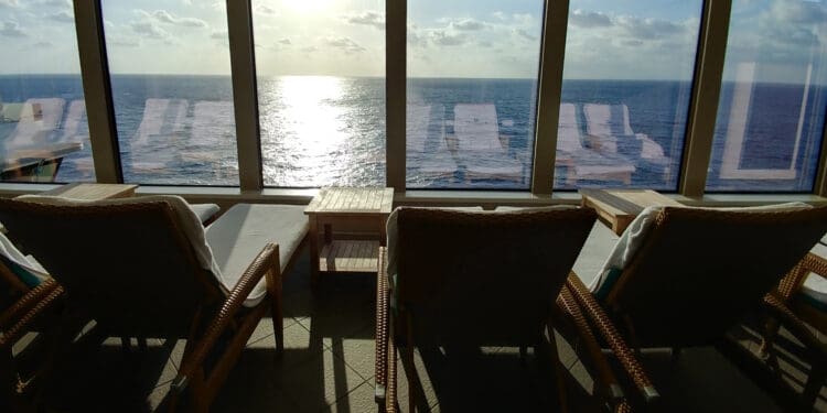 a room with chairs and a view of the ocean
