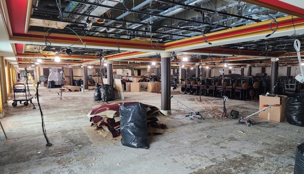 a room with many chairs and a large black bag