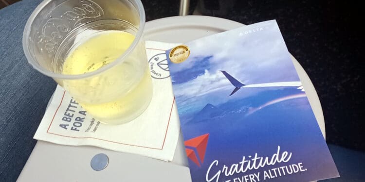 a cup of beer and a card on a table