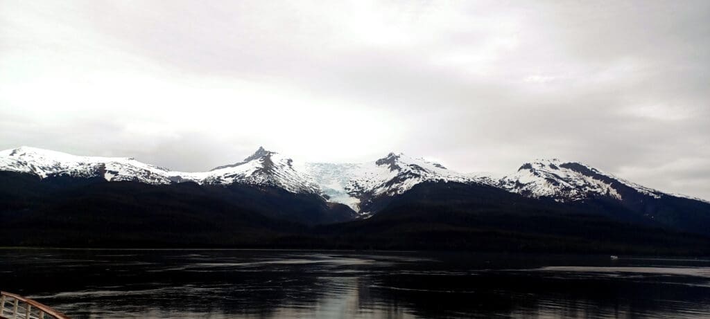 a lake with snow covered mountains