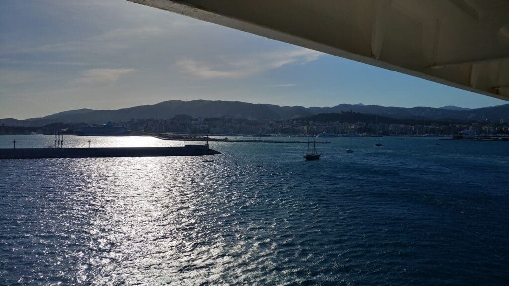 a body of water with boats and a city in the background