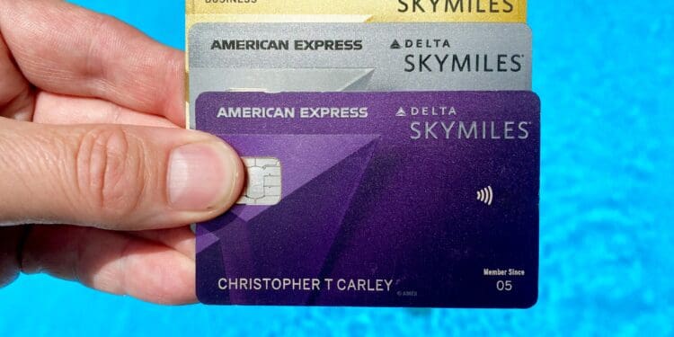 Delta SkyMiles@ American Express Cards against a blue swimming pool background.