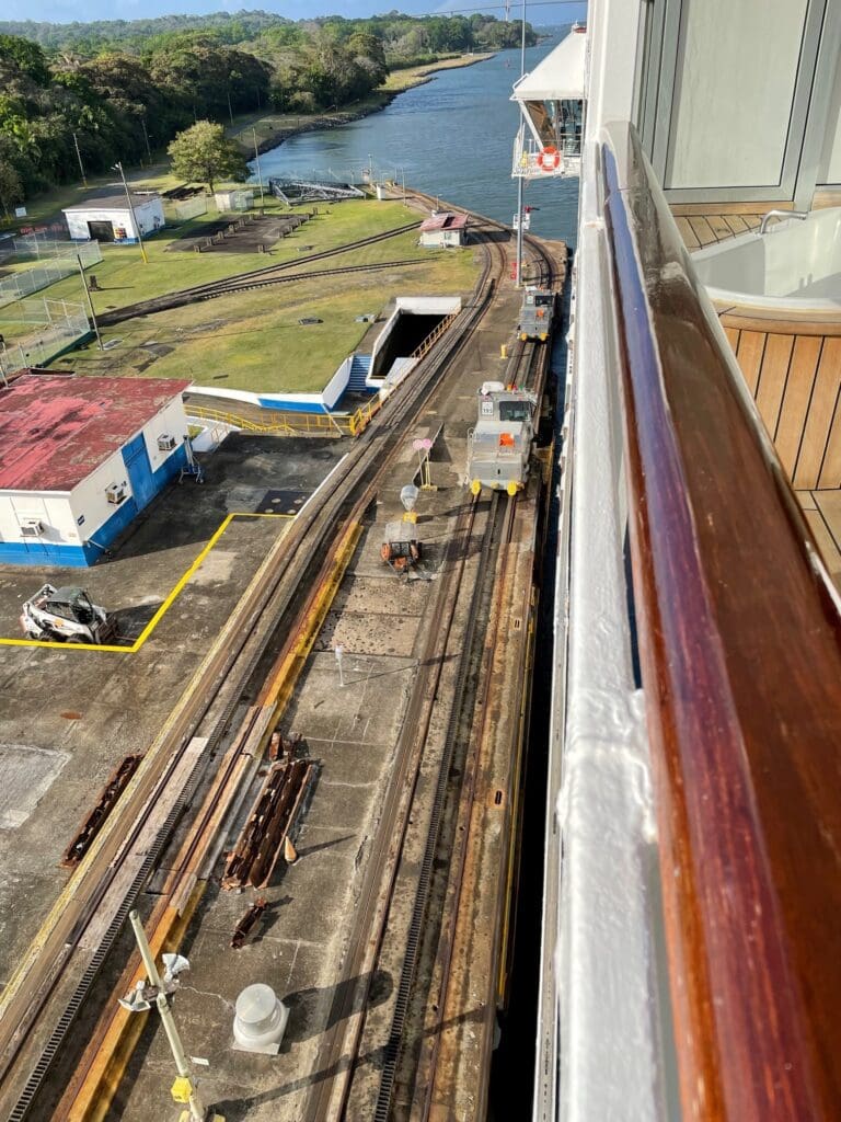 a train tracks next to a body of water