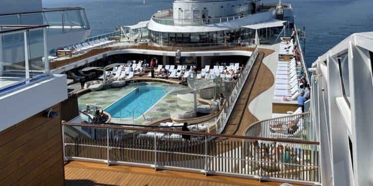 a deck of a cruise ship with a pool in the background