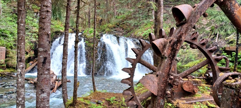 a water fall with a large metal gear