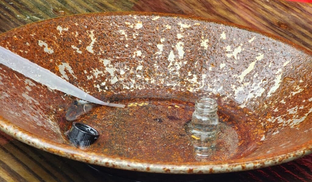 a bowl with a small bottle in it