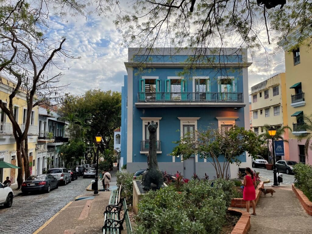 a blue building with a statue of a dinosaur