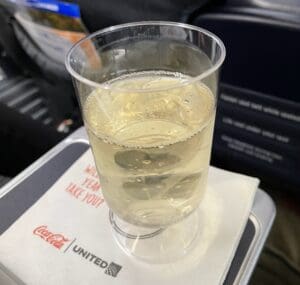 a clear glass of liquid on a tray