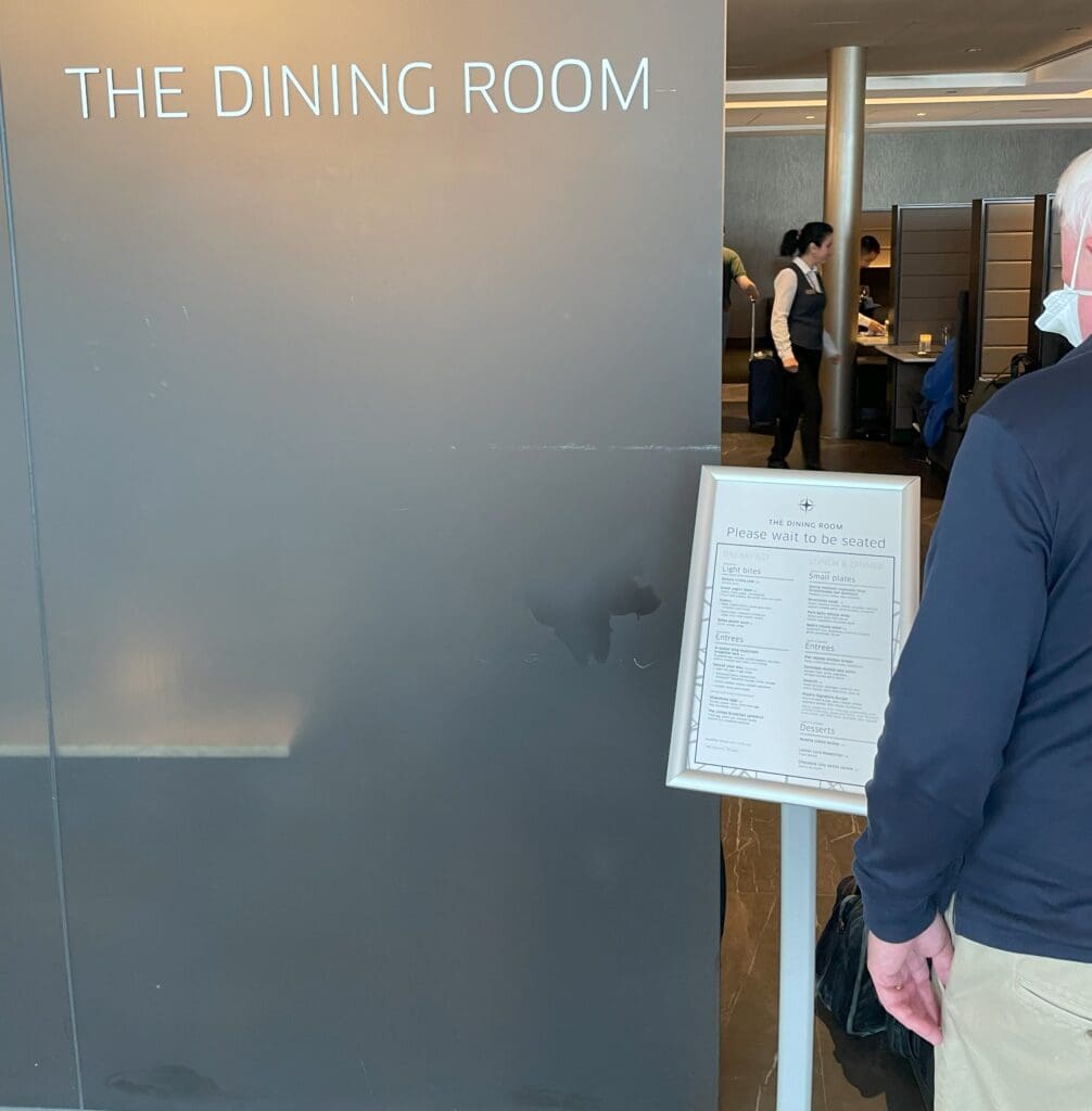 a man standing in front of a sign