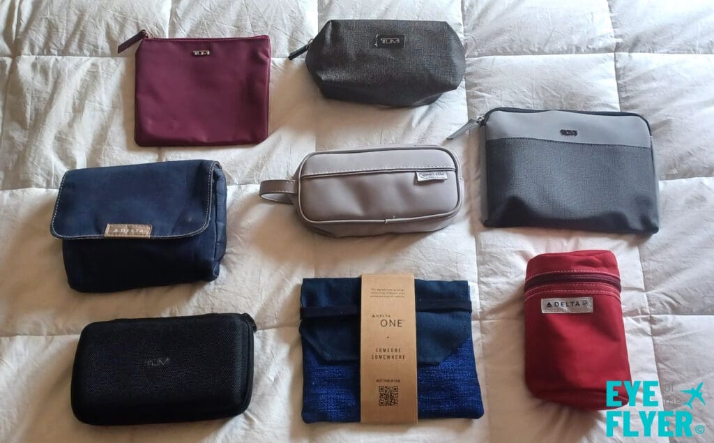 a group of different bags on a bed