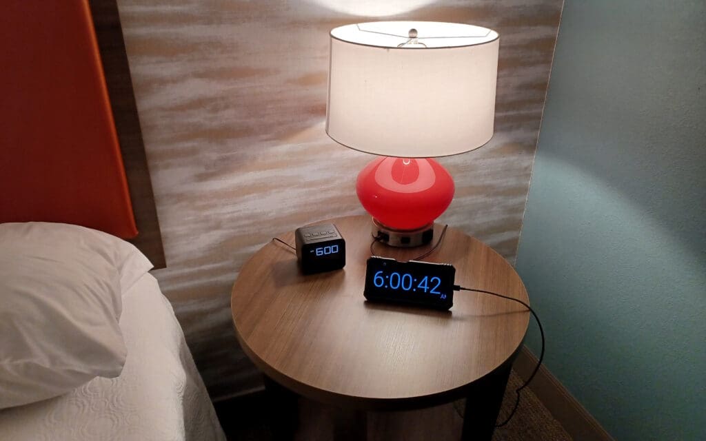 a table with a lamp and a clock on it
