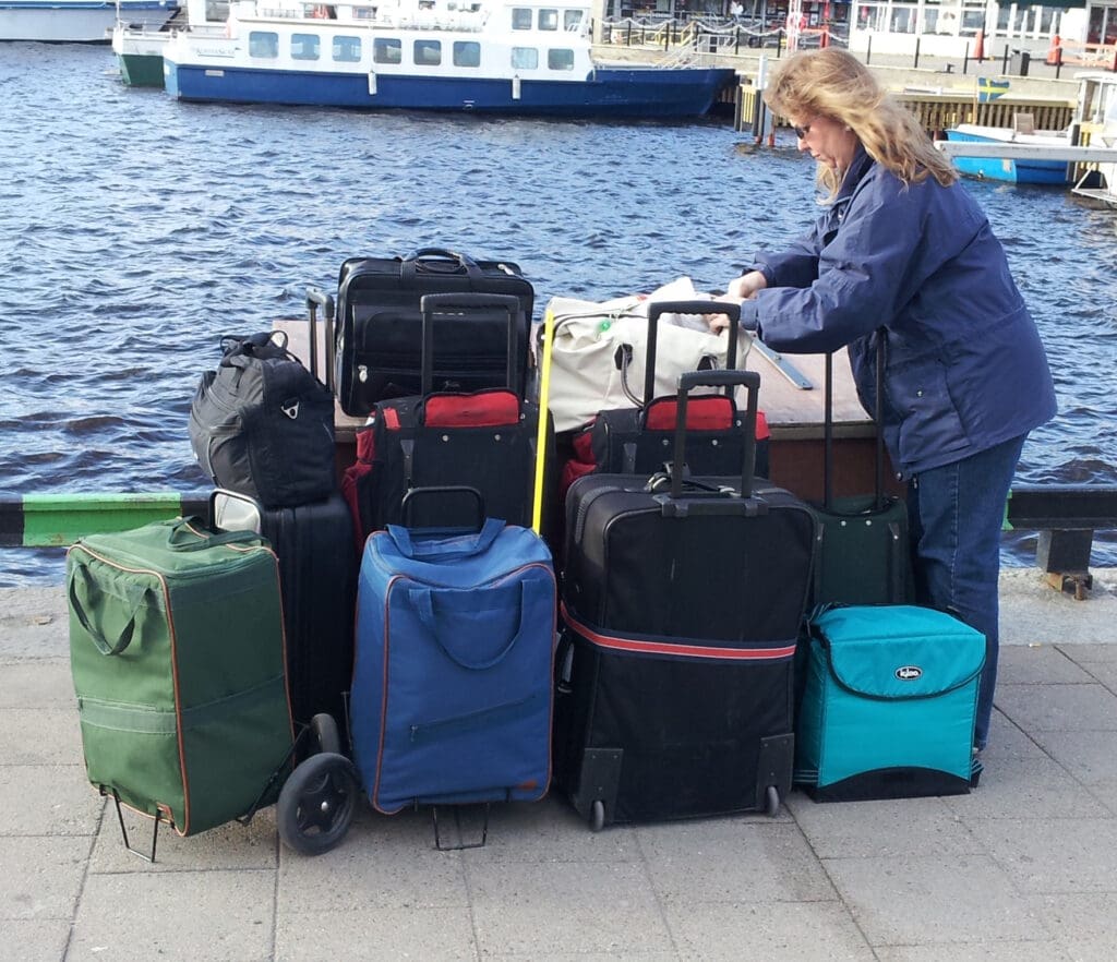 a woman standing next to a pile of luggage