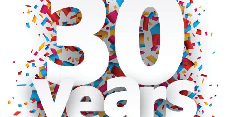 Thirty years paper sign over confetti.