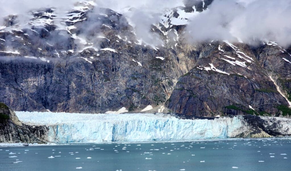 a glacier next to a body of water