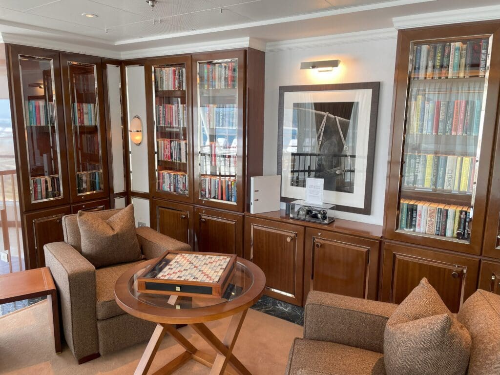 a room with a bookcase and chairs