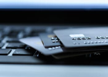 Close up shot of credit card on Laptop computer payment for purchases from online stores and online shopping. Concept of internet purchase. Selective focus for background