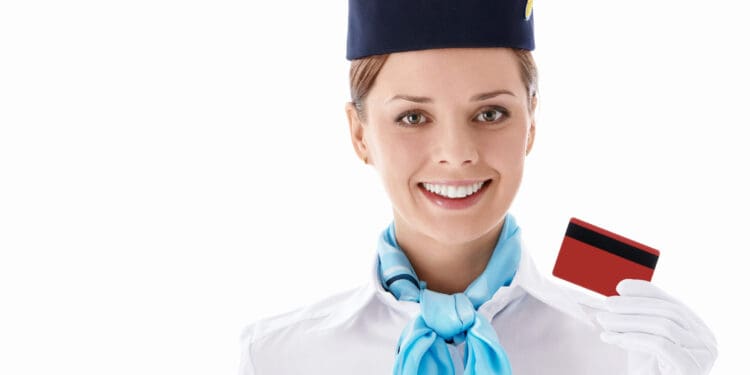 Flight attendant holding up a credit card
