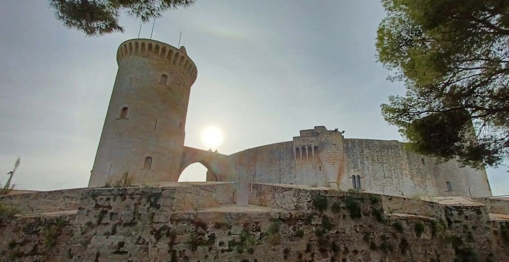 a stone castle with a stone wall and a stone tower