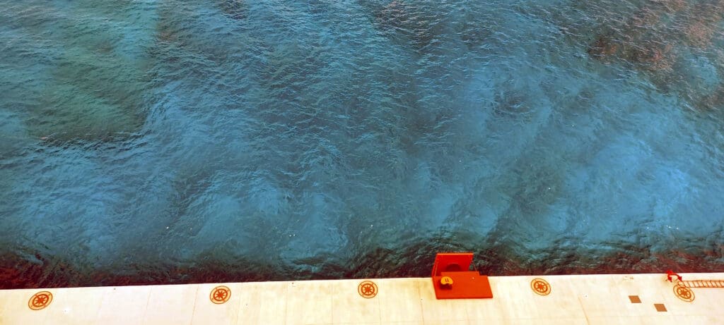 a body of water with a pier and a red box