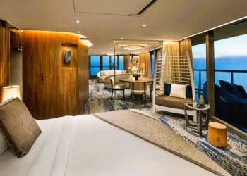 a room with a bed and chairs