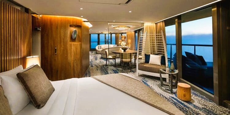 a room with a bed and chairs