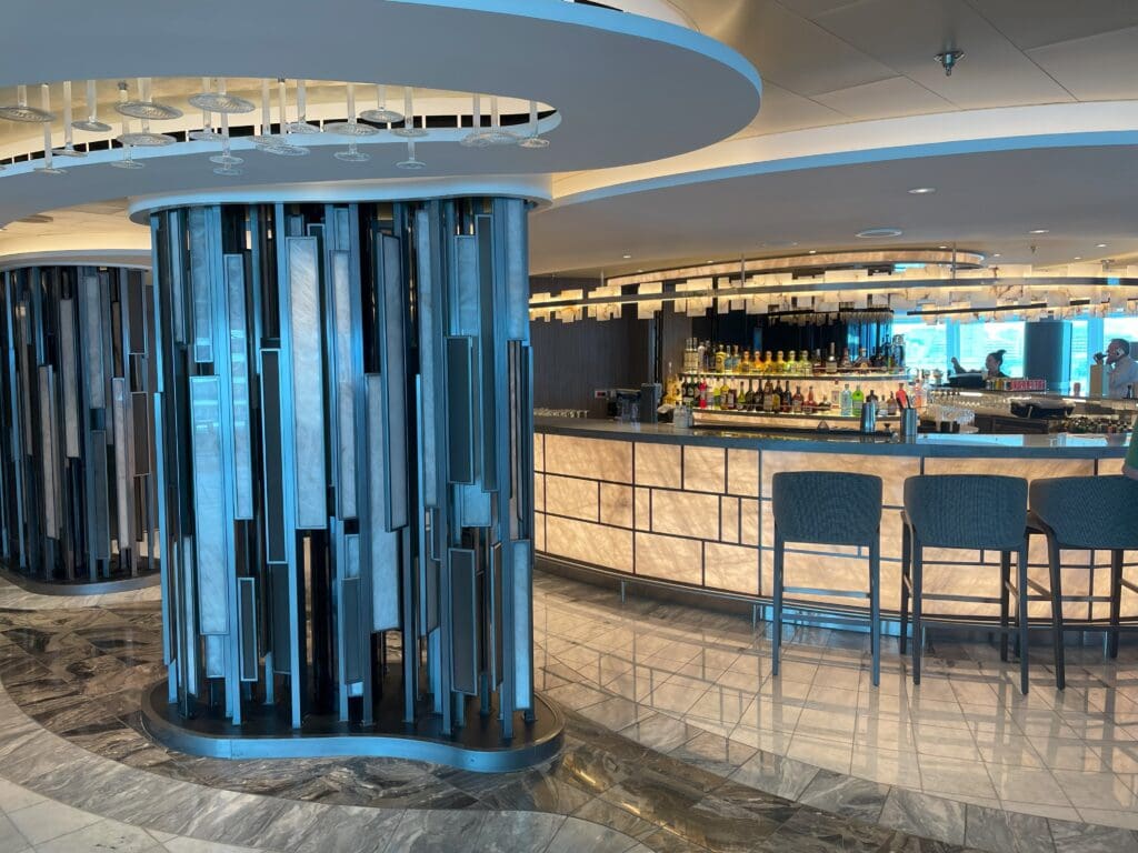 a bar with a round column and chairs