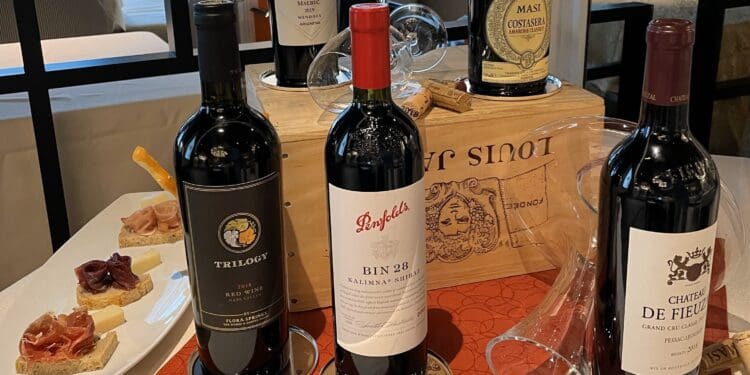 a table with wine bottles and a tray of food