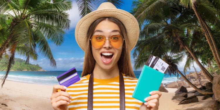 Excited traveler holding an airline boarding pass and a credit card
