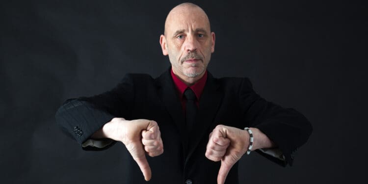 Handsome man doing different expressions in different sets of clothes: thumbs down (©iStock.com/Chris_Paris)