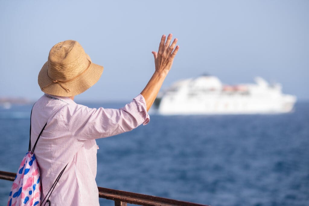 a person standing on a railing overlooking a large ship