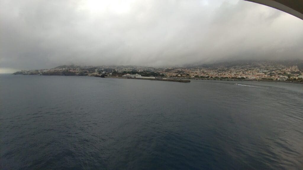 a body of water with a city in the background