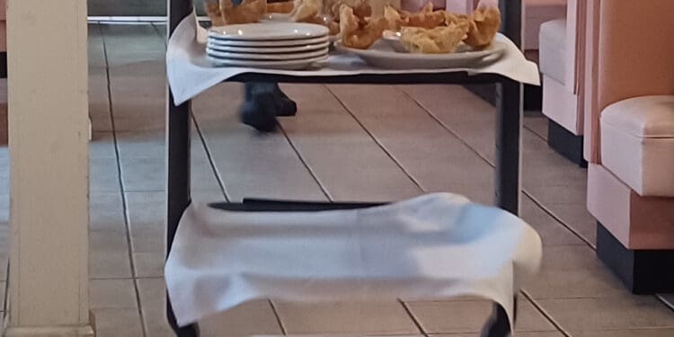 a cart with a screen and plates on it