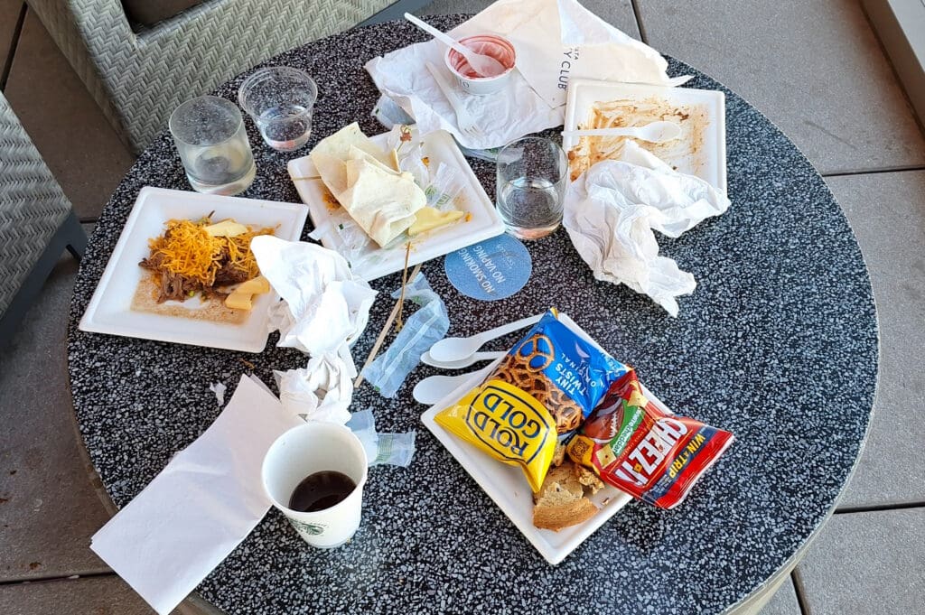 a table with plates of food and drinks
