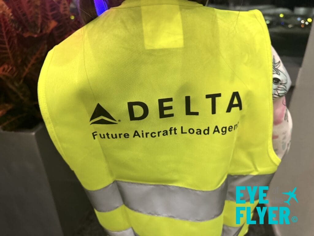 a yellow vest with black text