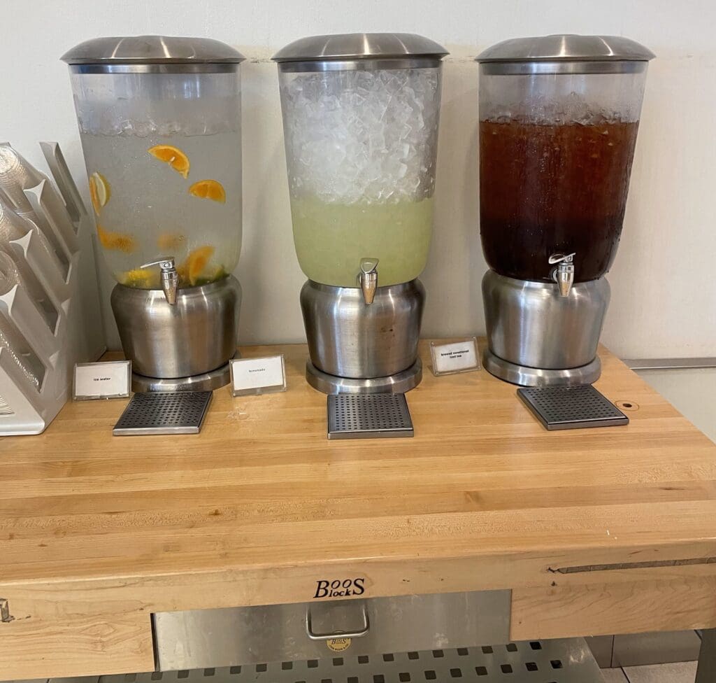 a group of beverage dispensers on a table