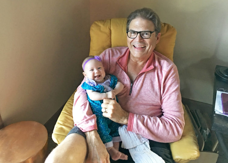 Our daughter with one of her favorite babysitters: Grampa!