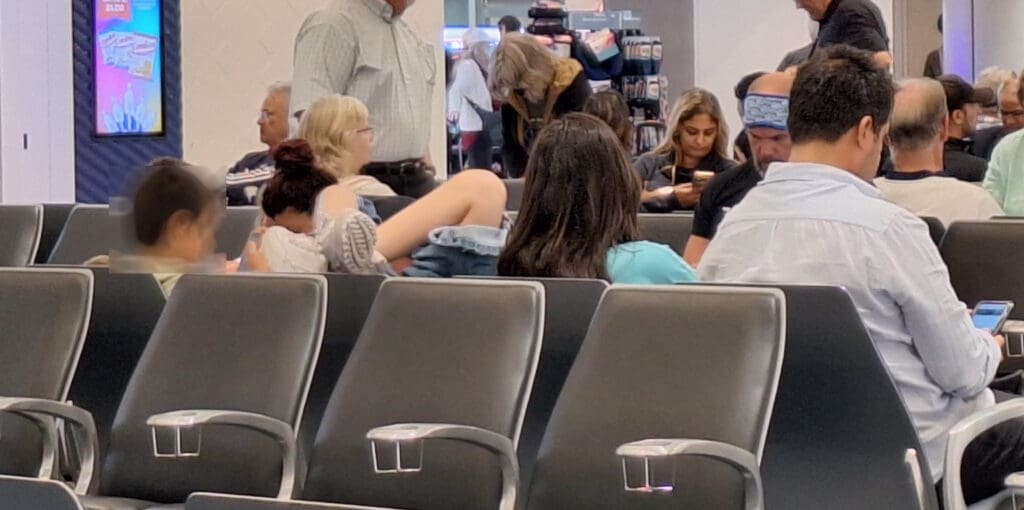 a group of people sitting in a row of chairs