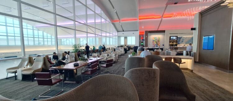 a group of people in a room with tables and chairs