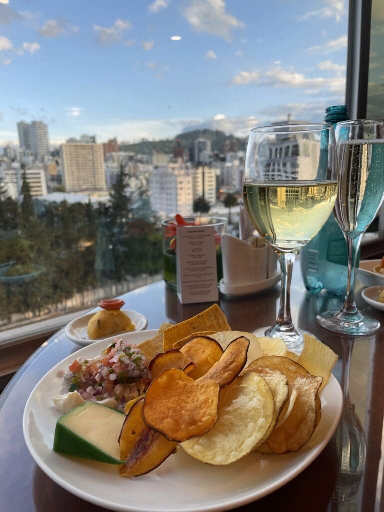 a plate of food and wine glasses on a table