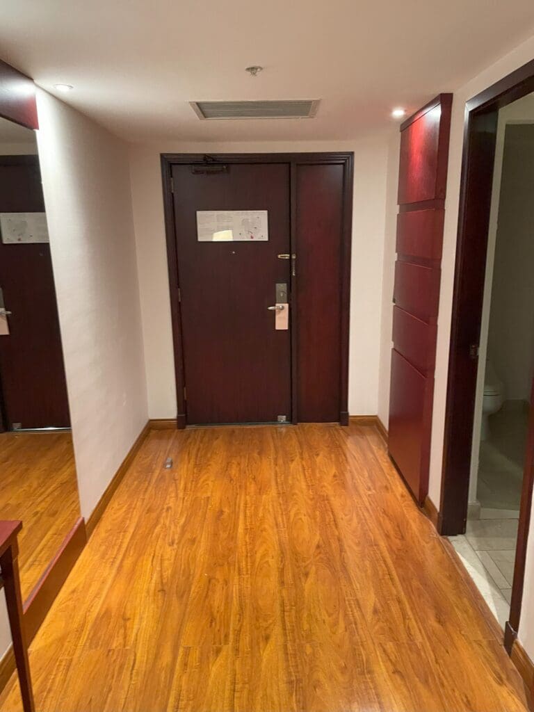 a hallway with a door and a wood floor