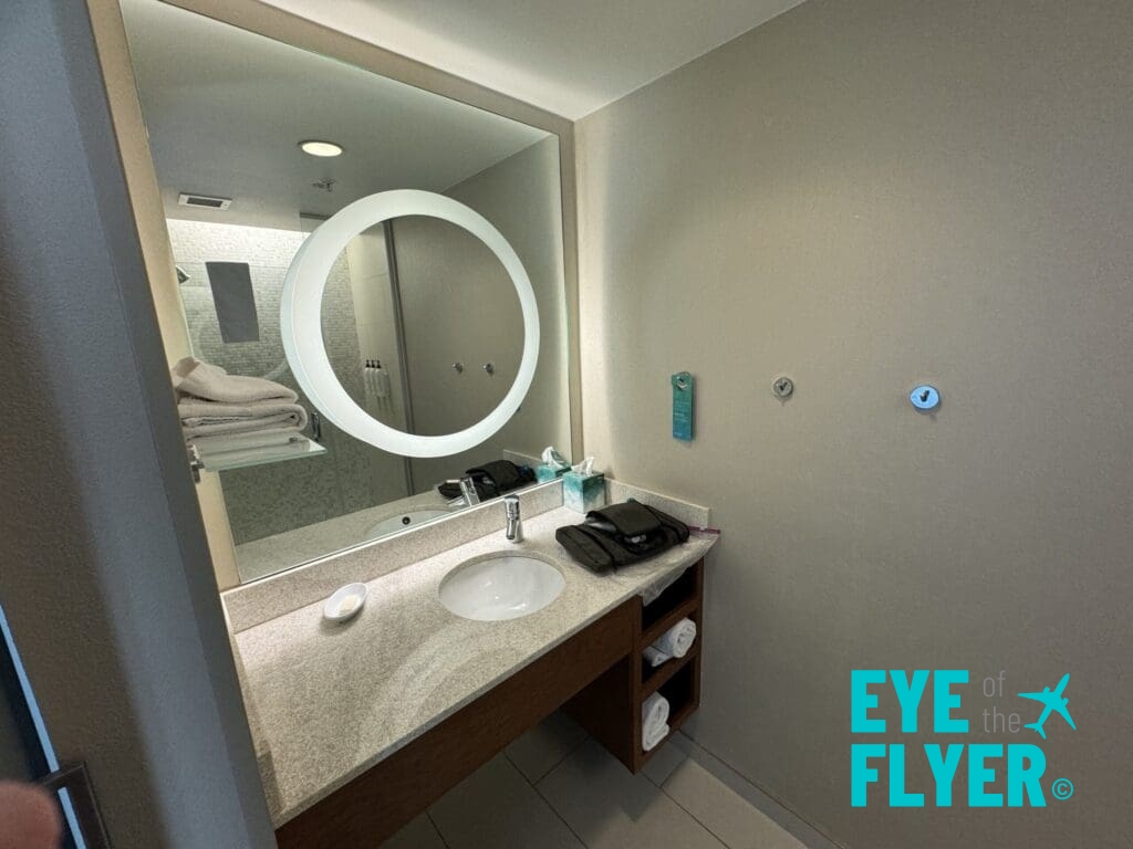 a bathroom with a mirror and sink SpringHill Suites Las Vegas Convention Center (© Eye of the Flyer)