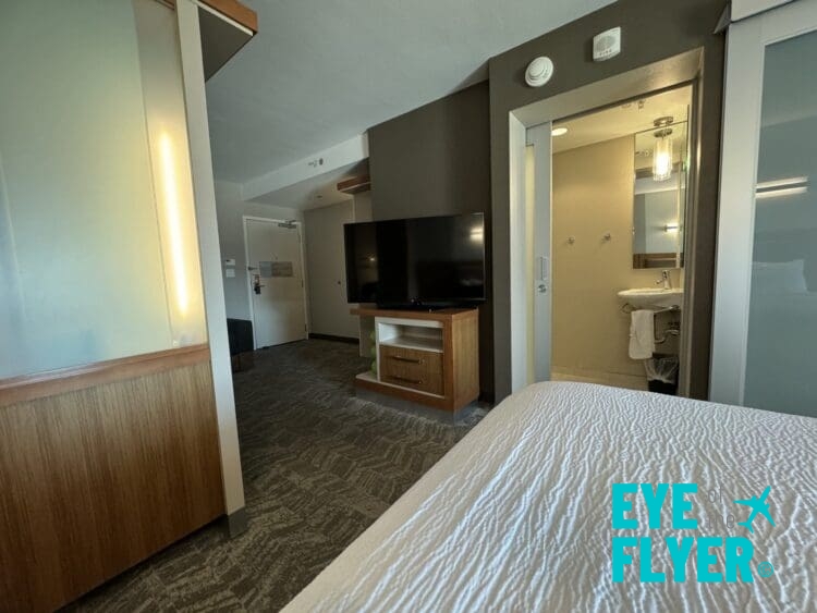 a room with a tv and a bed