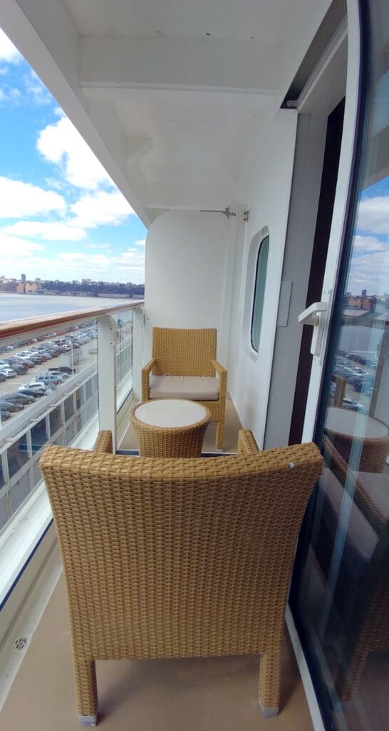 a balcony with chairs and a table