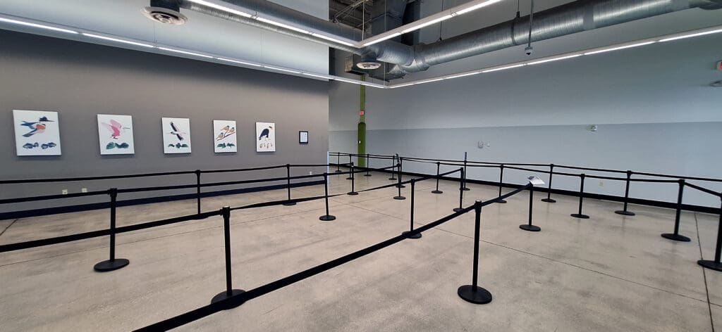 a room with black railings and pipes