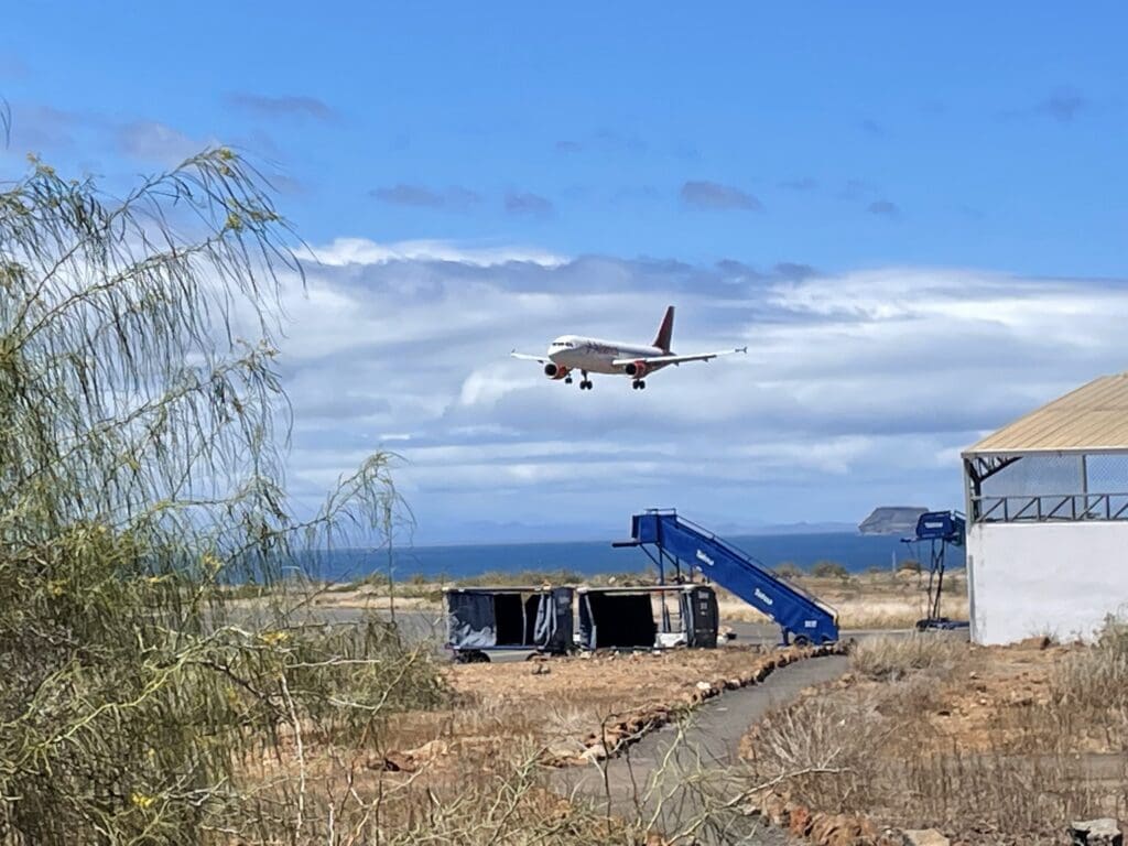 an airplane flying over a runway