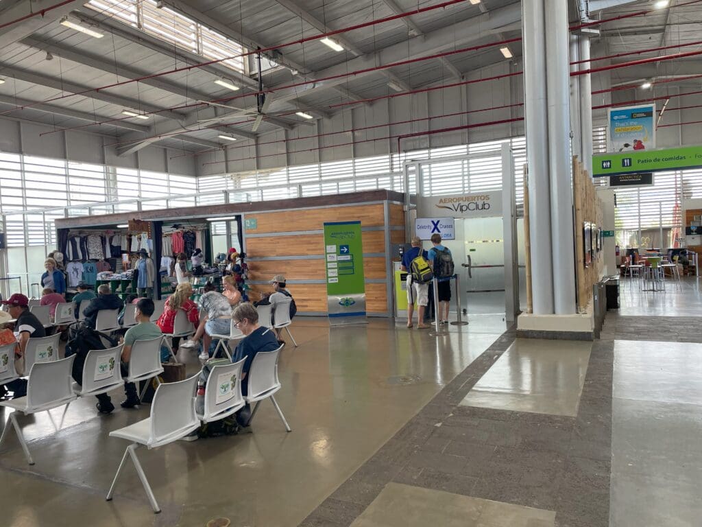 a group of people sitting in chairs in a large building