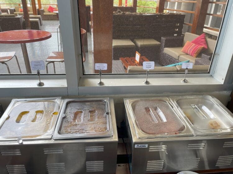 a group of metal containers with food in them