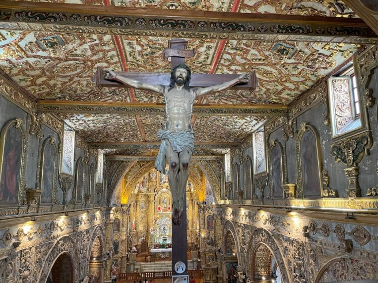 a statue of a man on a cross in a church