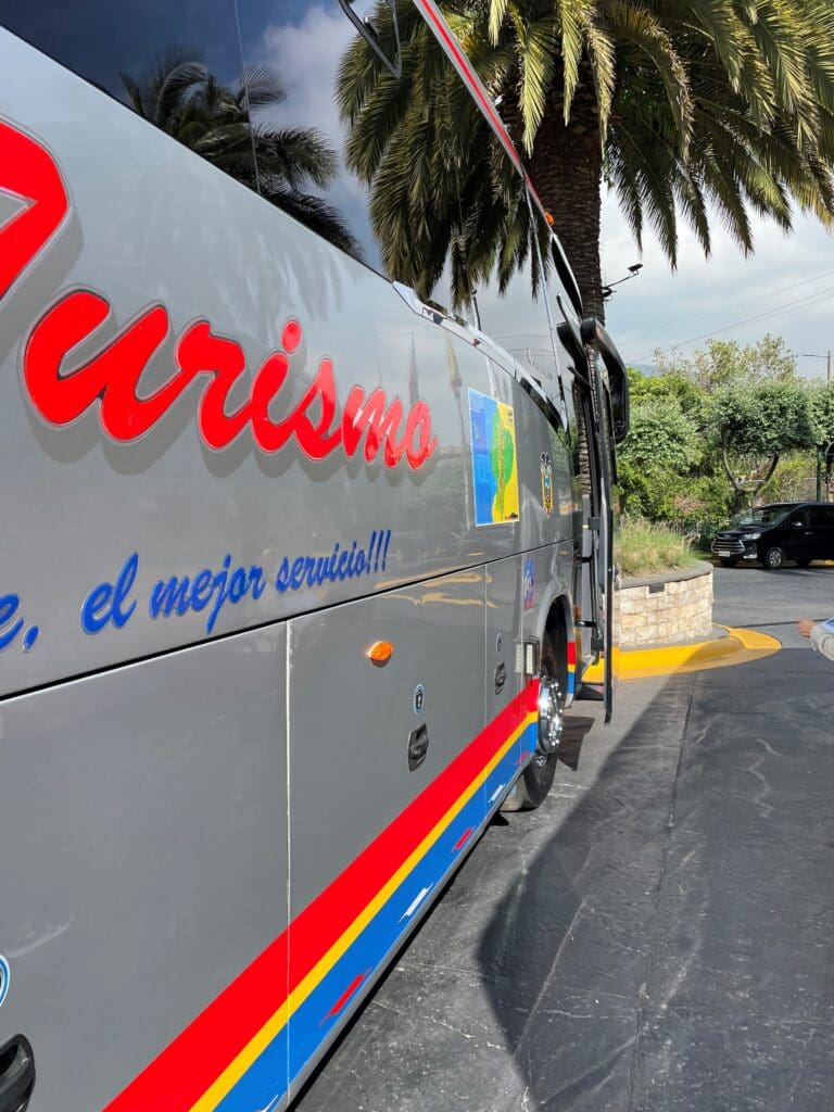 a grey bus with red and blue writing